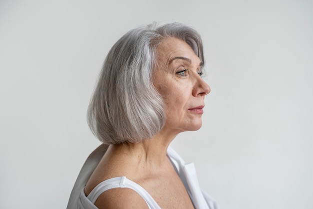 Foto elegante alte frau, die weiße kleidung trägt