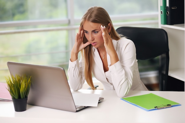 Foto elegante empresaria sentada en su oficina