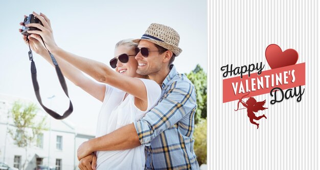 Foto elegante jovem casal tirando uma selfie contra feliz dia dos namorados