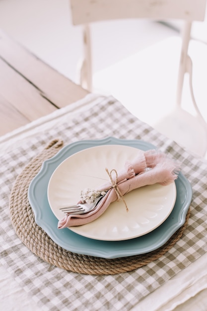 Elegante mesa rústica com garfo de metal e guardanapos de linho no prato