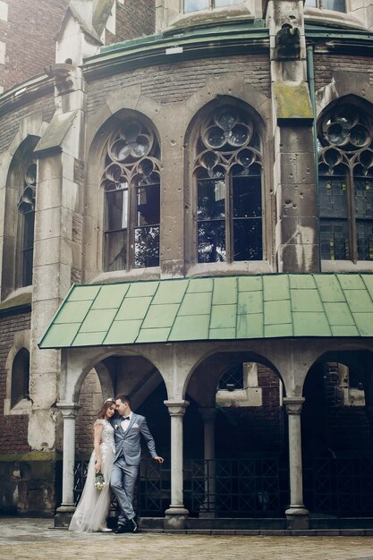 Elegante noiva e noivo abraçando-se no fundo da velha igreja Momento romântico Casamento da Provence