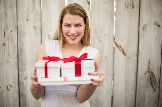 Elegante rubia ofreciendo regalos de Navidad