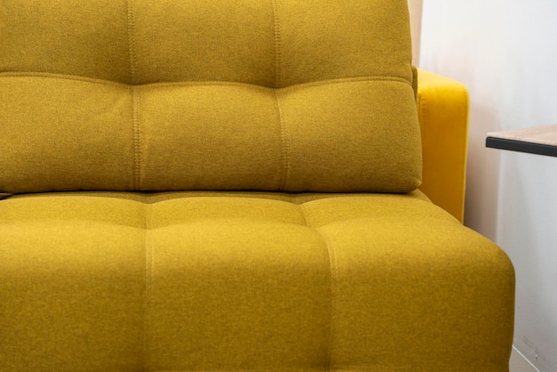 Elegante sofá amarillo de moda con muebles de salón de respaldo en minimalismo