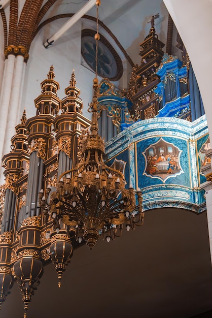 Eleganter Kronleuchter mit Orgel im Inneren der lettischen Kathedralen