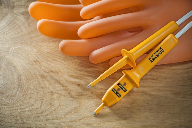 Elektrische Tester dielektrische Handschuhe auf Holzbrett.