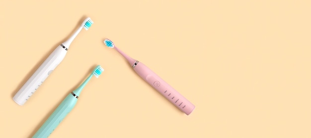 Elektrische Zahnbürste Draufsicht flach legen Kopierraum Zahnpflegebedarf auf beige Pastell Studio Hintergrund Mundhygiene Zahnfleisch Gesundheit gesunde Zähne modernes zahnärztliches Ultraschall-Vibrations-Zahnbürsten-Set
