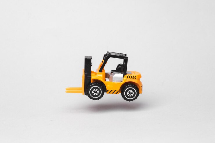 Foto elevador de garfo de brinquedo em miniatura voando em antigravidade em fundo cinza com sombra levitação de objeto no ar conceito de transporte logístico layout minimalista criativo