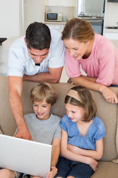 Foto eltern, die kindern beibringen, laptop zu benutzen