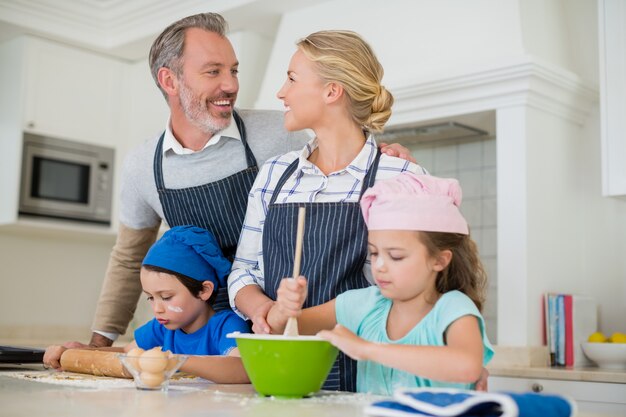 Eltern und Kinder bereiten Essen in der Küche zu