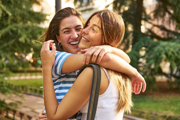 Em meio à beleza da natureza, amigos felizes se abraçam em um parque