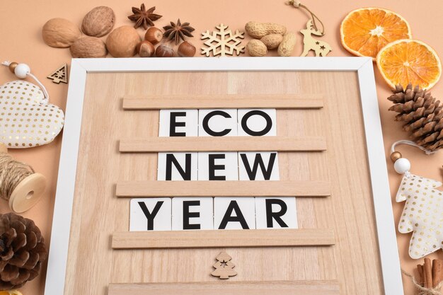 Em uma placa de madeira, há uma inscrição econew year decorações naturais para o ano novo e o natal