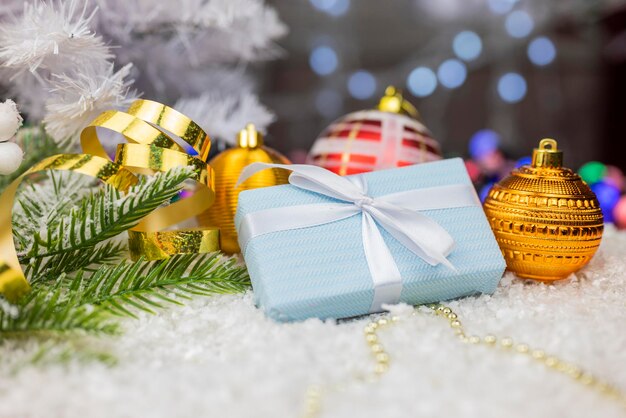 Embalaje de cajas de regalo con lazo y cinta de color azul y adornos con bolas de juguetes