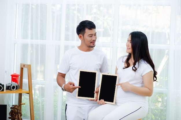 La embarazada está feliz con su marido, preparándose para mirar al niño que está a punto de dar a luz.