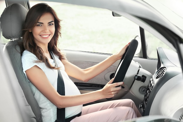 Embarazada joven conduciendo coche