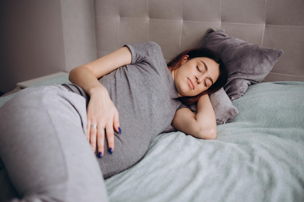 Embarazo descanso personas y concepto de expectativa mujer embarazada feliz durmiendo en la cama en casa