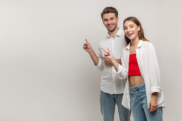 Emocionado sonriente pareja hombre y mujer freelancer grito wow mira copia espacio punto aislado onwhite