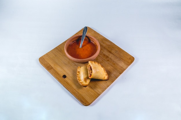 Empanadas e molho quente em uma mesa