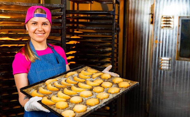 Empanadas en un fondo de producción de panadería Bollos y pasteles frescos Manos sosteniendo dos bollos