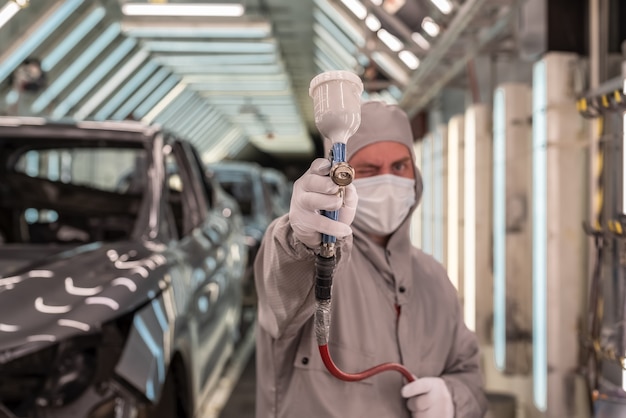 Empleado pintando la carrocería