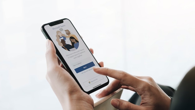 Un empleado que trabaja desde casa está descargando la plataforma social de Microsoft Teams, lista para trabajar a distancia en forma aislada de su hogar