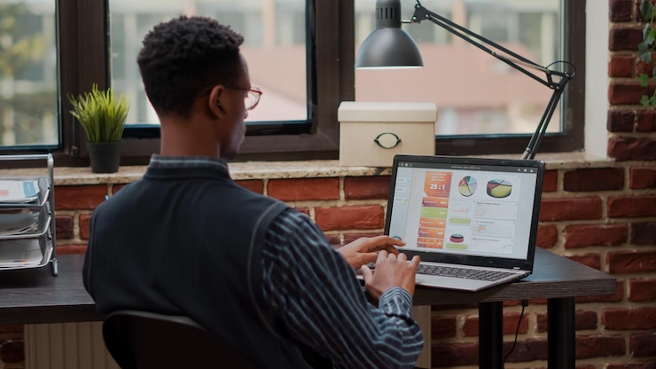 Foto empleado que usa una computadora portátil para planificar la inversión profesional en la oficina de inicio. hombre de negocios que trabaja en gestión y marketing con estadísticas de ventas en computadora. consultor financiero en el trabajo