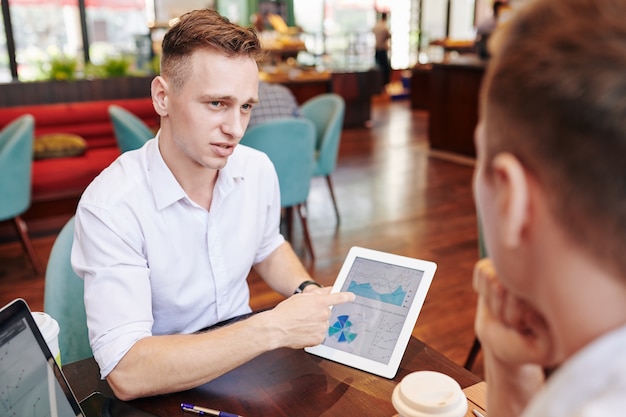 Empreendedor discutindo relatório com colega