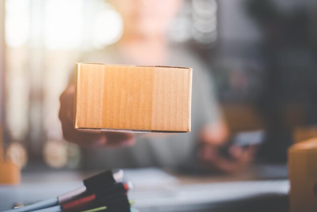 Emprendedores en fase de puesta en marcha o pequeñas empresas con cajas en la mano manejando pedidos en