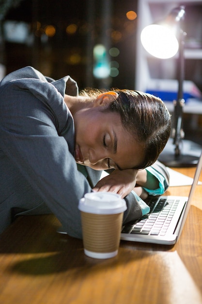 Foto empresária, dormindo enquanto trabalhava no escritório