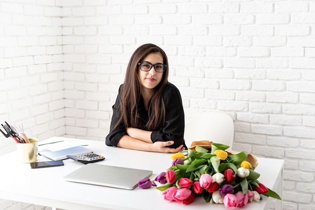 empresária trabalhando com flores no escritório