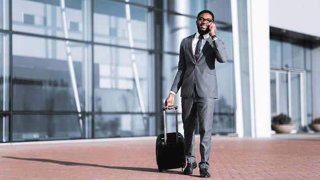 Empresário afro-americano falando ao telefone no aeroporto