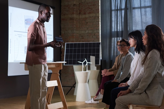 Empresário apresentando bateria solar para as pessoas