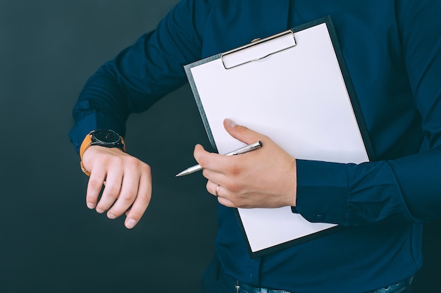 Foto empresario con carpeta para documentos y reloj en sus manos