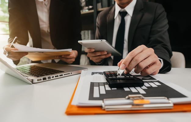 Empresário de brainstorming e discutindo com dados financeiros e gráfico de relatório no escritório em casa.