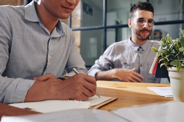 Empresário escrevendo no planejador