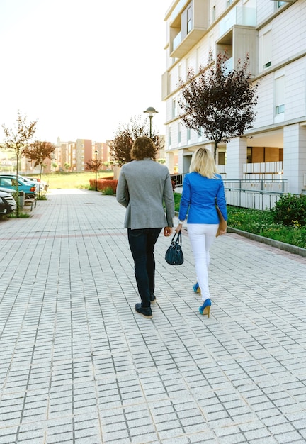 Empresario irreconocible y empresaria caminando hacia su oficina