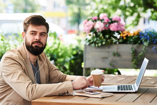 Empresário moderno usando Laptop no café