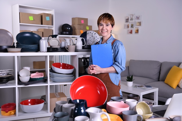 Foto empresario de mujer asiática madura, propietario de un negocio mirando y sonriendo a la cámara mientras trabaja en casa