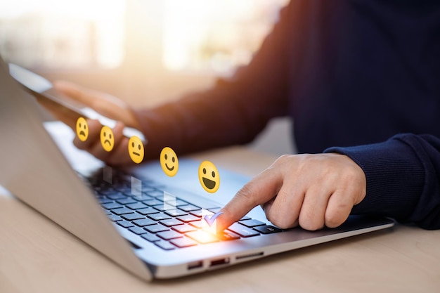 Empresario presionando sonrisa en el teclado de la computadora portátil evaluación del servicio al cliente conceptrating a la experiencia de servicio en la aplicación en línea Encuesta de comentarios de satisfacción de revisión del cliente Comentarios negativos