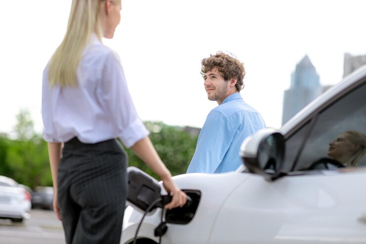 Foto empresário progressivo e empresária com carro ev e estação de carregamento