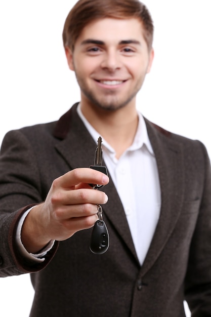 Foto empresário segurando a chave do carro isolada no branco