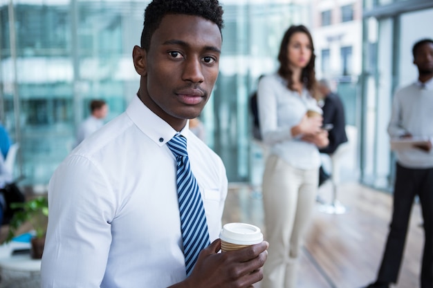 Empresário segurando café no escritório