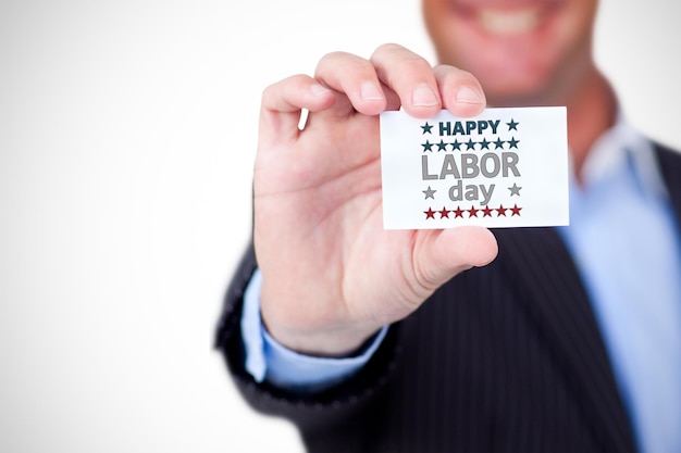 Empresário segurando cartão em branco contra fundo branco contra texto feliz do dia do trabalho com forma de estrela