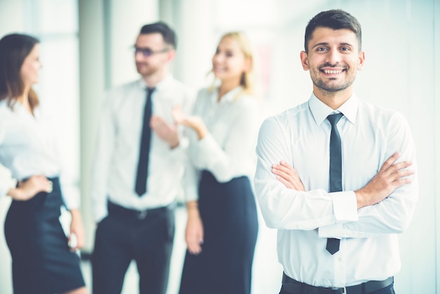 El empresario de la sonrisa está parado cerca de socios