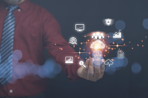 Empresario sosteniendo una bombilla con computación en la nube en las manos con un icono de negocios con espacio de copia Base de datos de seguridad y redes digitales la tecnología de negocios para el concepto futuro