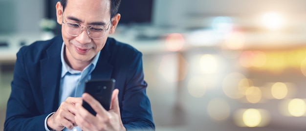 Empresário usando smartphone e laptop vista tirada do lado do elefante