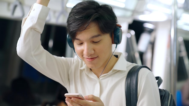 Empresario usando teléfono móvil en tren público. Concepto de desplazamiento de estilo de vida de ciudad urbana.