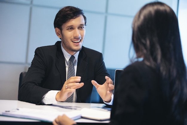 Empresários e empresárias discutindo documentos para o conceito de entrevista de emprego