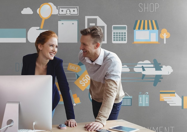 Empresários felizes em uma mesa usando um computador contra um fundo cinza com gráficos