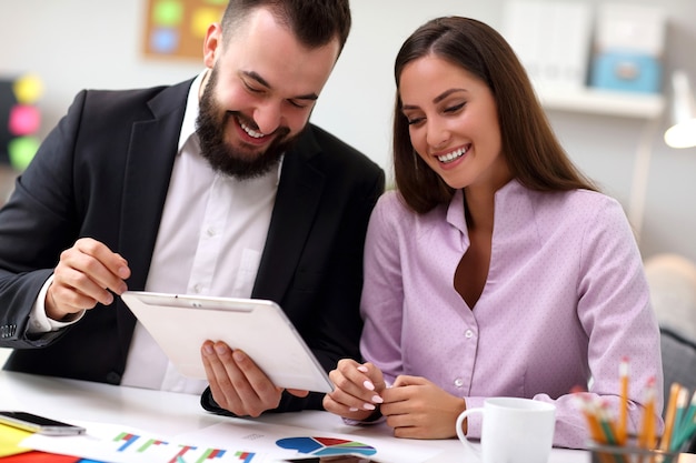 Empresarios trabajando juntos en la oficina con tableta