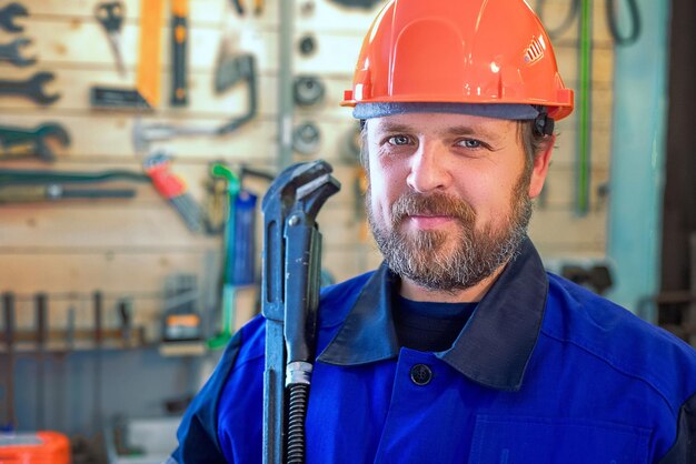 Encanador de trabalho barbudo com grande chave na mão